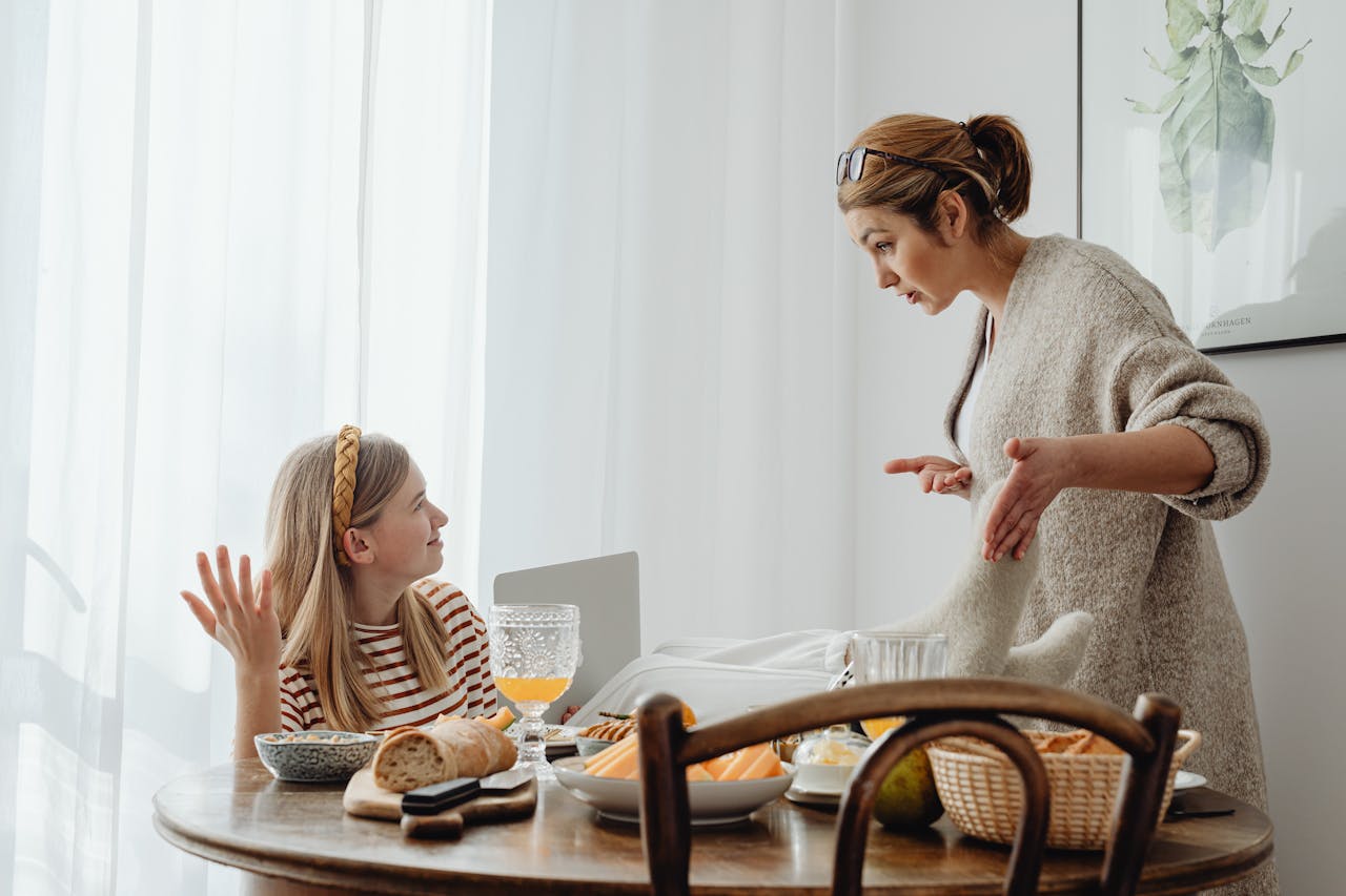 mother and daughter arguing at the dinner table